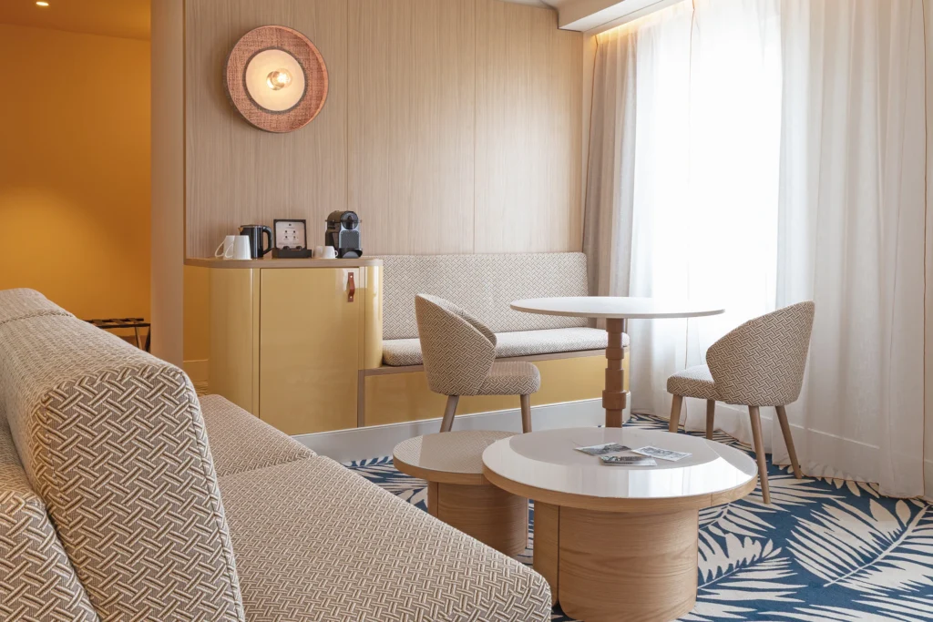 Photographie d’architecture de la suite de du Grand Hôtel Beauvau MGallery à Marseille, avec espace salon, canapé, coin café et lumière naturelle, par Armando Garcia